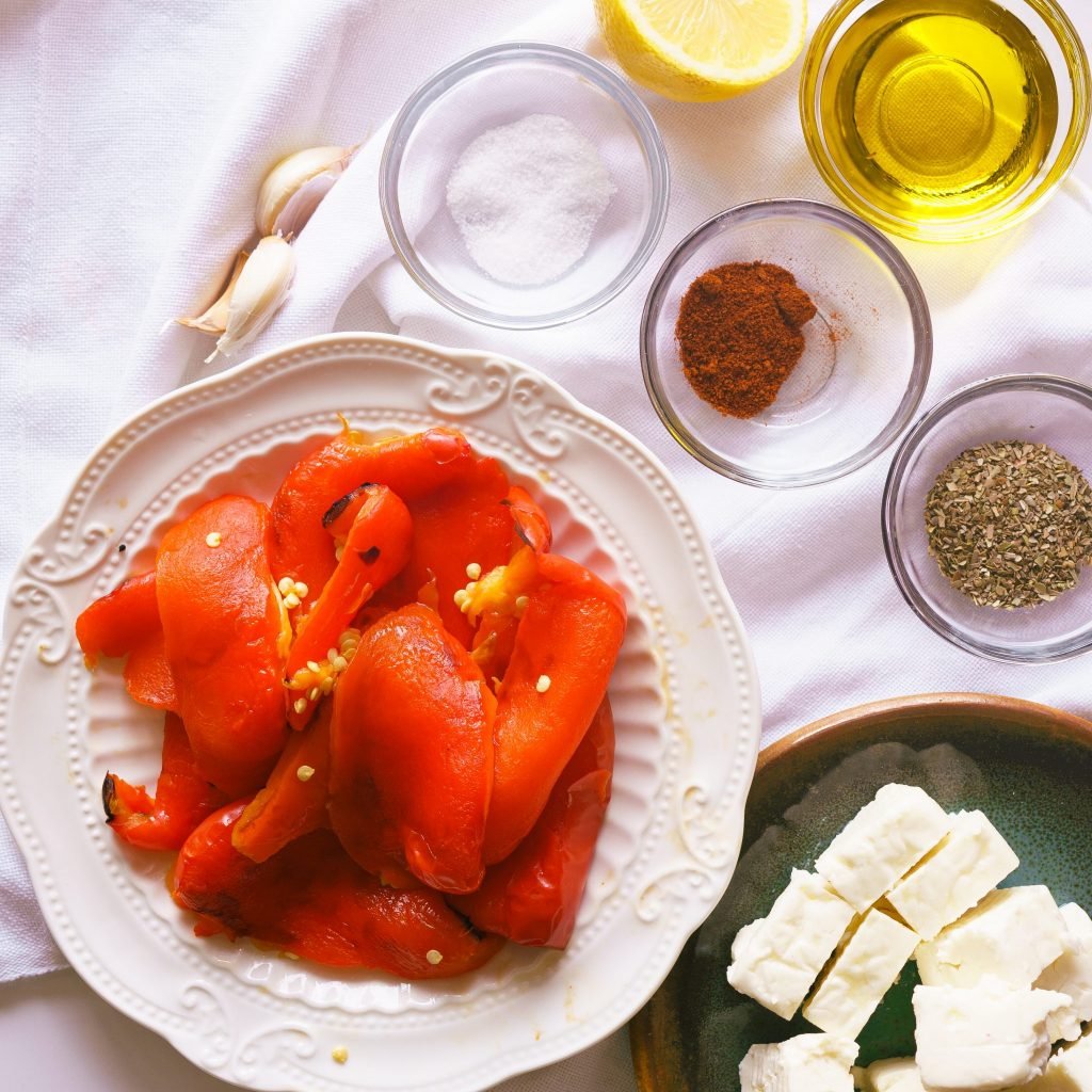 skinless roasted peppers with the ingredients for red pepper feta dip