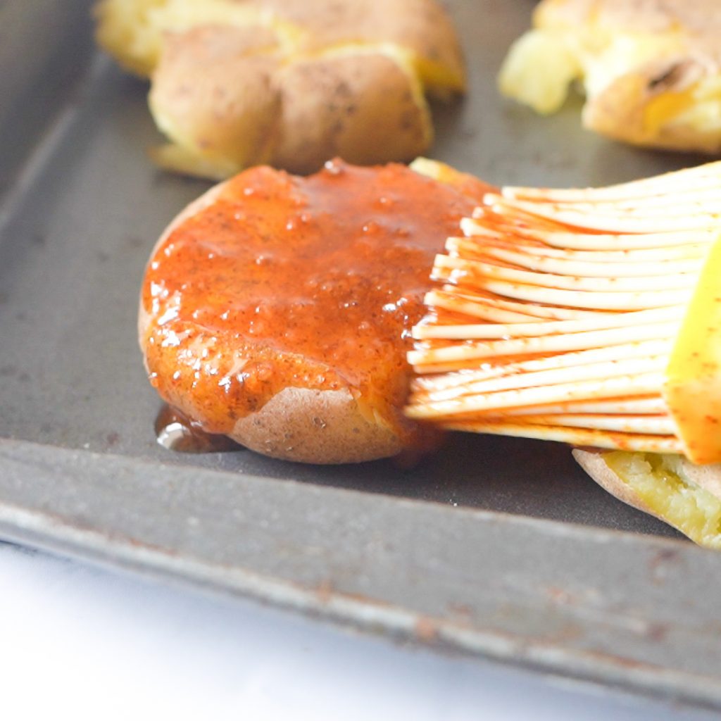 brushing the potato with garlic rosemary butter