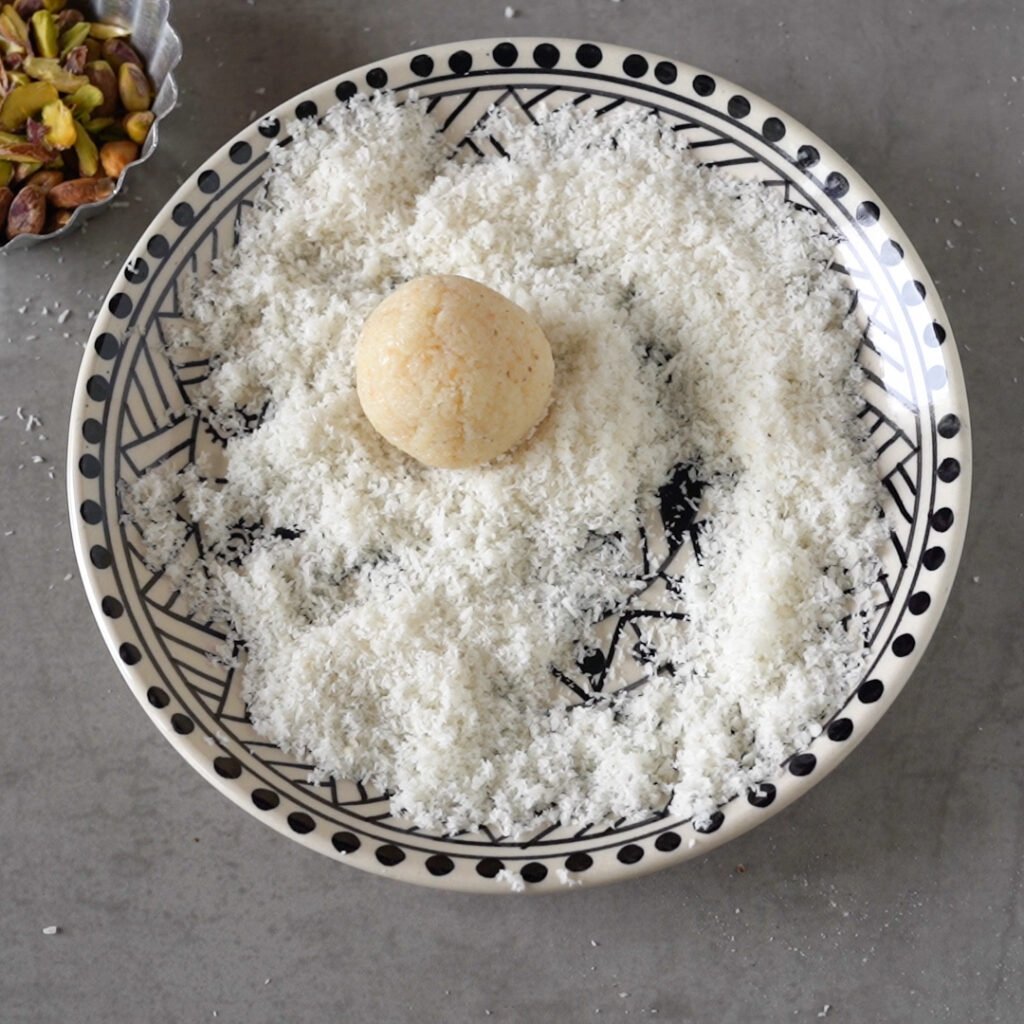 Roll the laddu in dried Coconut