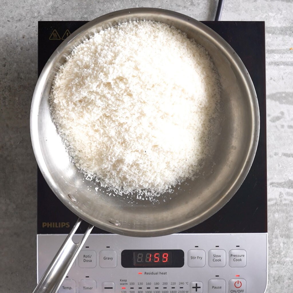 Toasting the coconut for coconut laddu with condensed milk