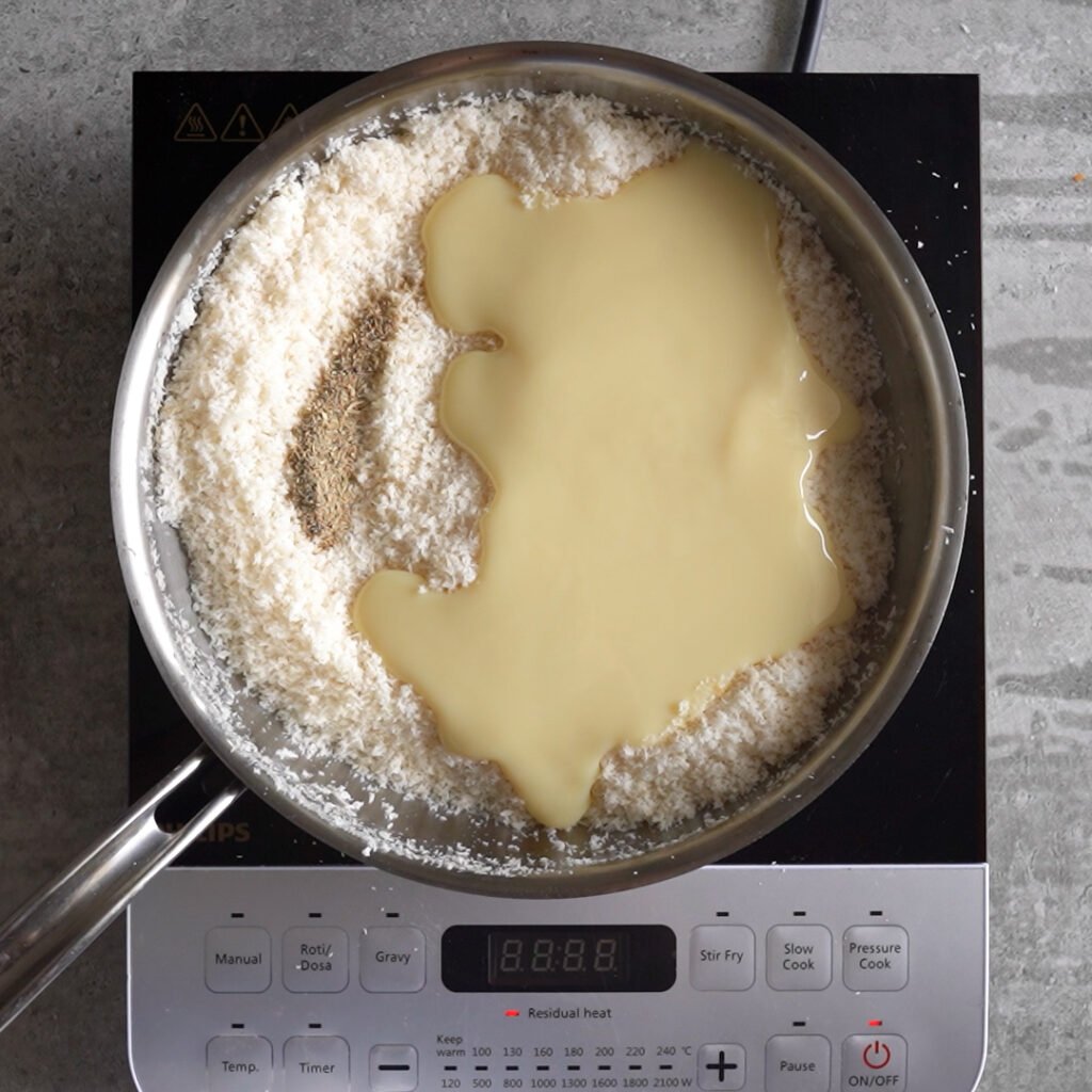 Adding Sweet Condensed milk to the Toasted coconut to make Coconut Ladoo