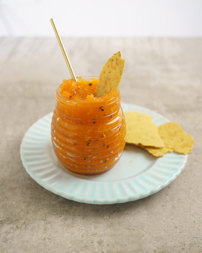 Cooked Sweet Mango chutney in a jar with khakra