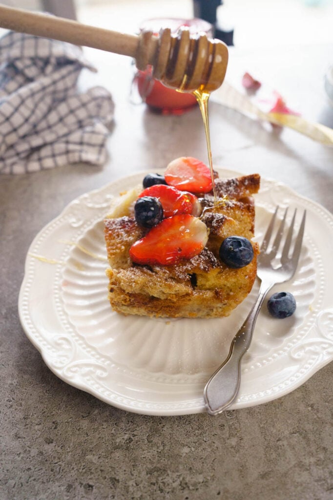 Drizzling honey over a slice of the brioche french toast