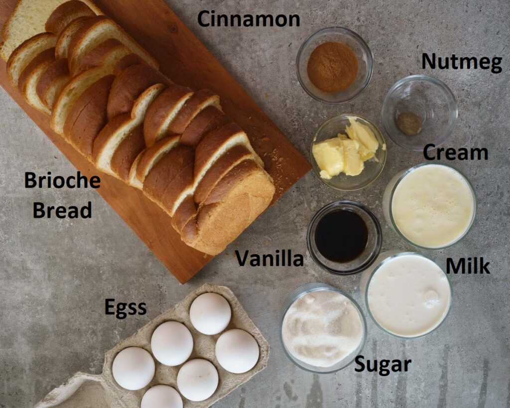 Ingredients to make Brioche French toast - brioche bread, eggs, sugar, milk, cream, butter, cinnamon and nutmeg in small glass bowls