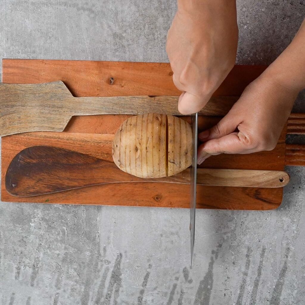 Slicing a Large Potato between two wooden spatulas