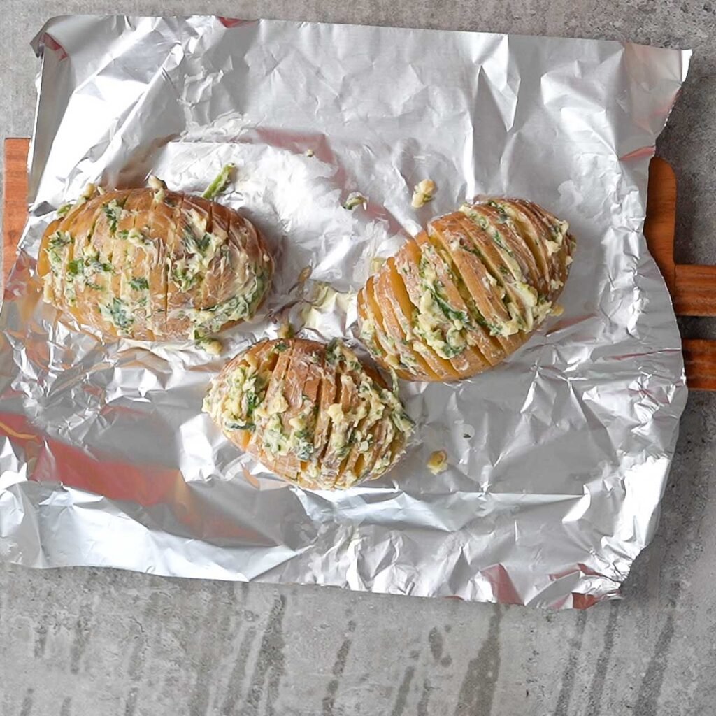 Herb & Garlic butter rubbed on the three hasselback cut potatoes.Just before air frying