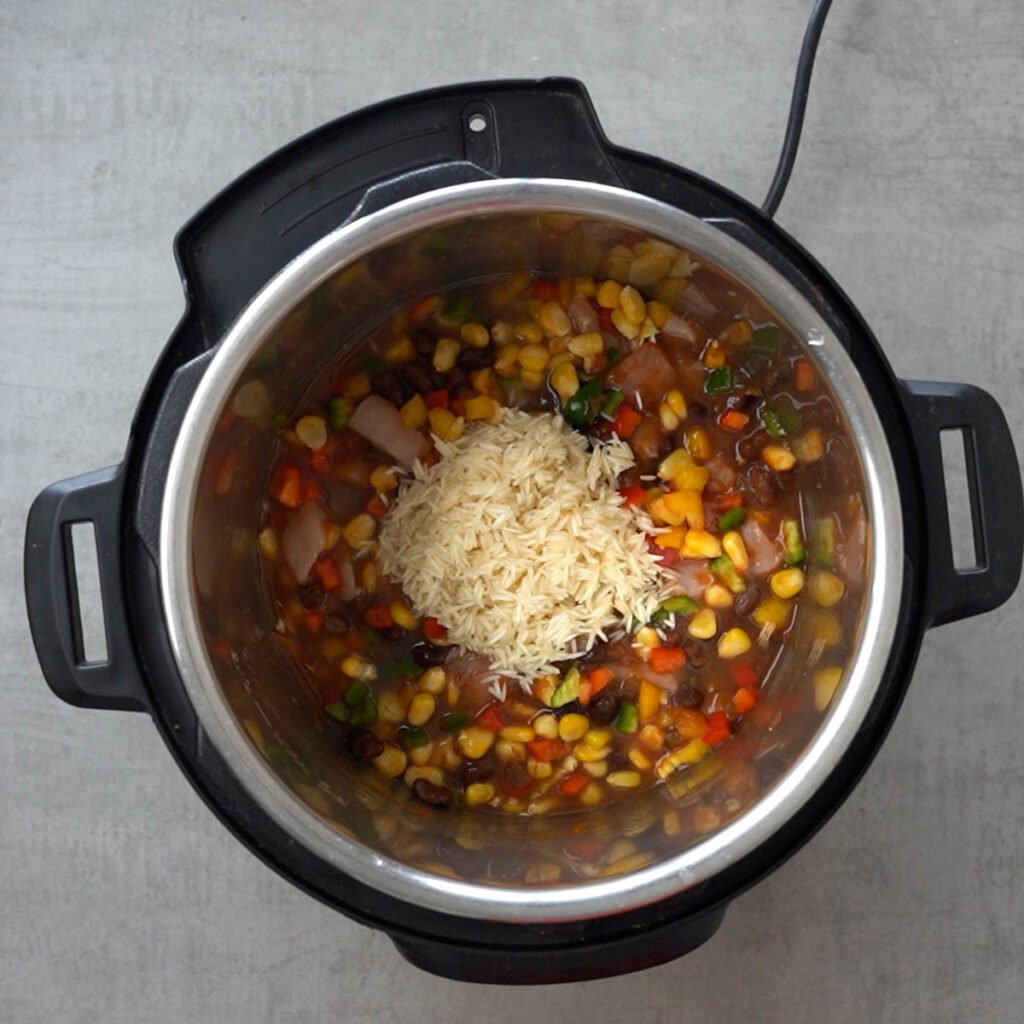 Rice over Chicken, beans, corn, salsa, water & diced bell peppers in the instant pot