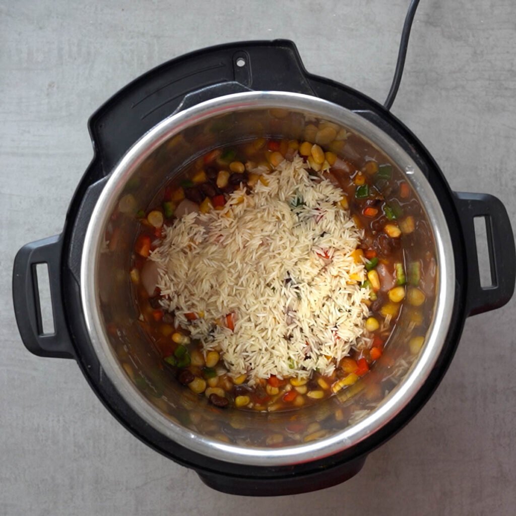 Rice over Chicken, beans, corn, salsa, water & diced bell peppers in the instant pot