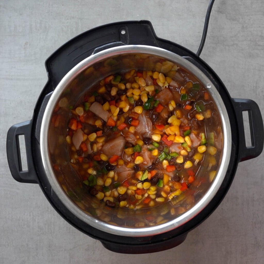 Chicken, beans, corn, salsa, water & diced bell peppers in the instant pot