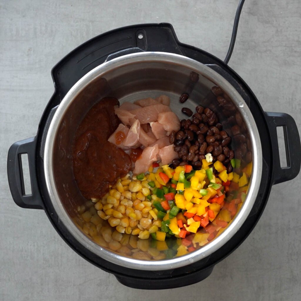 Chicken, beans, corn, salsa, water & diced bell peppers in the instant pot