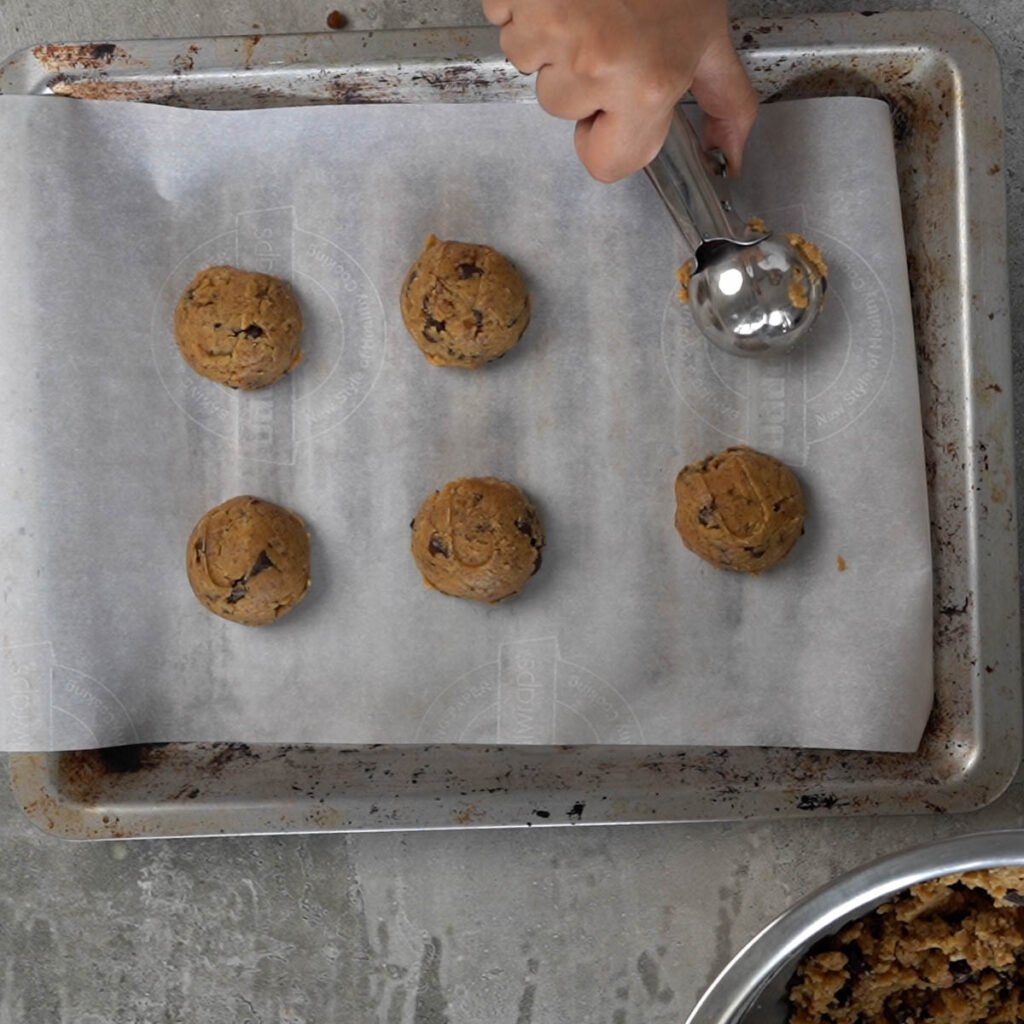 Scooping cookie on a cookie sheet