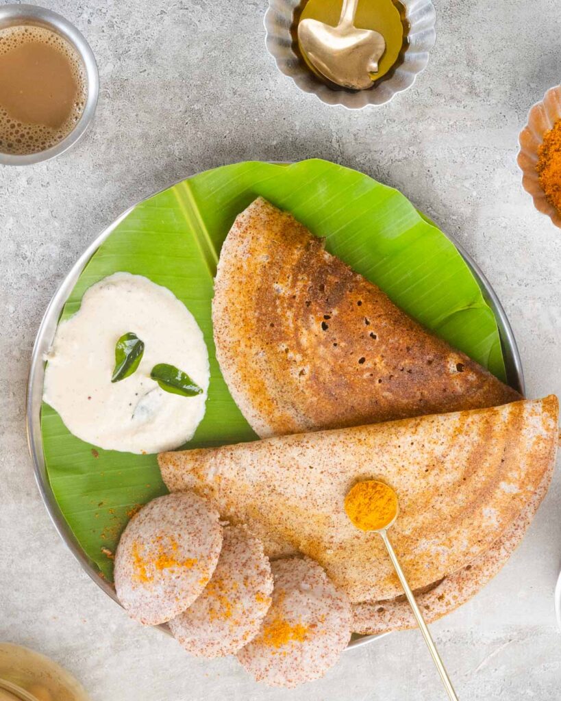 Ragi Dosa and Ragi idli on a plate with banana leaf , served with coconut chutney