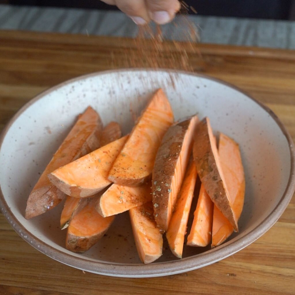 seasoning in the sweet potato wedges