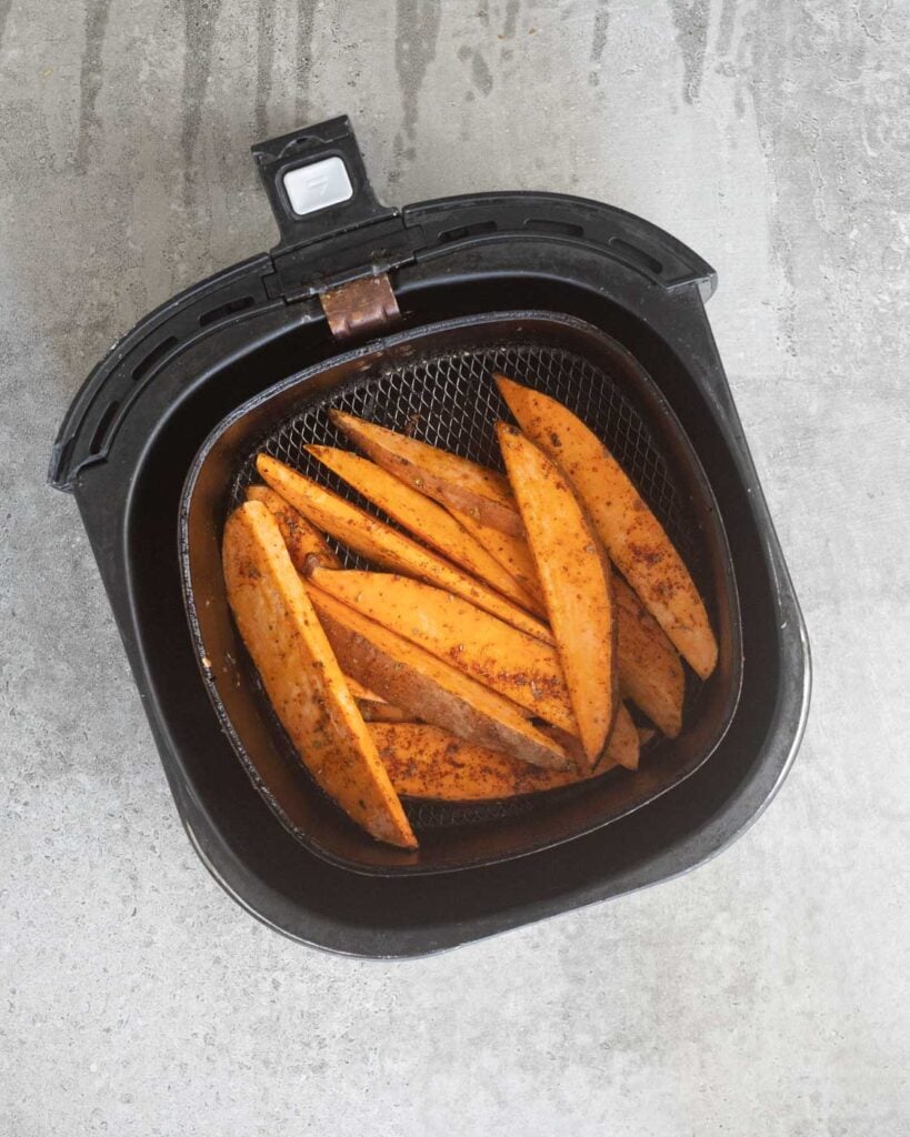Sweet Potato wedges in the air fryer basket before being cooked