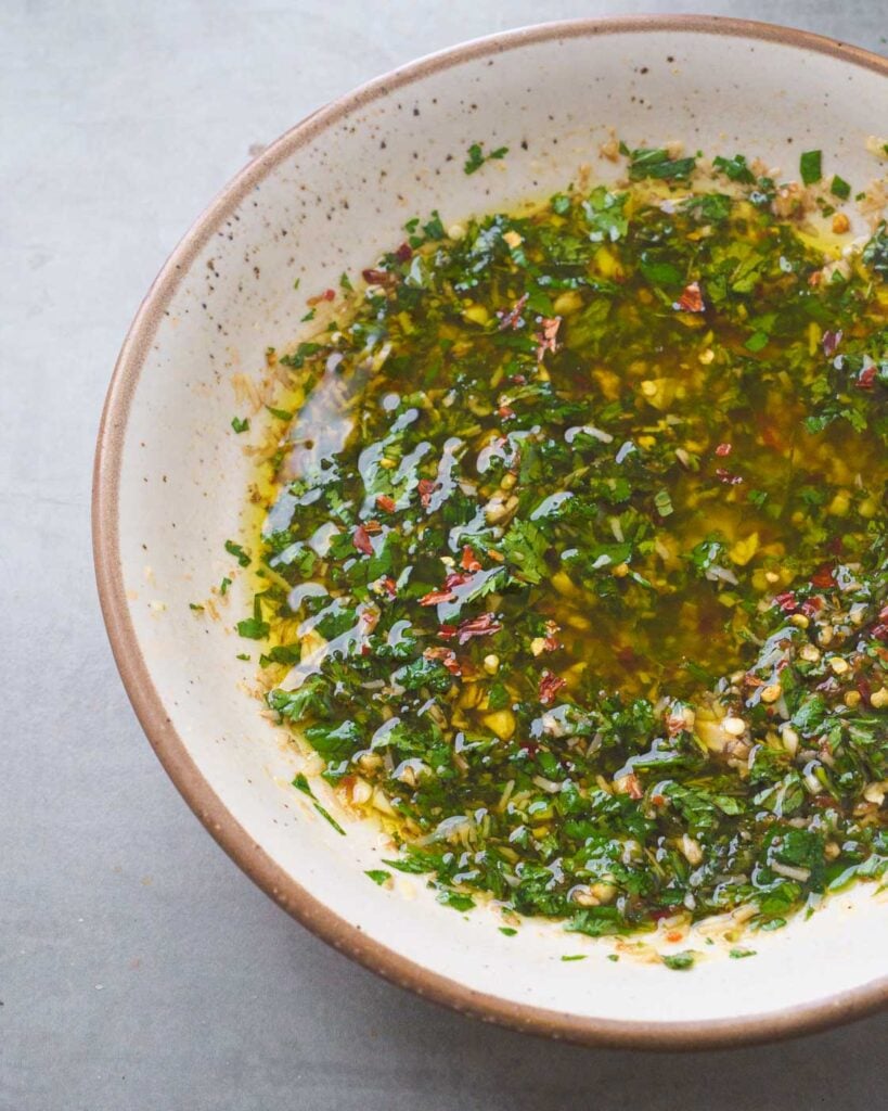 Olive Oil & Balsamic Herb Bread Dip in a white bowl 