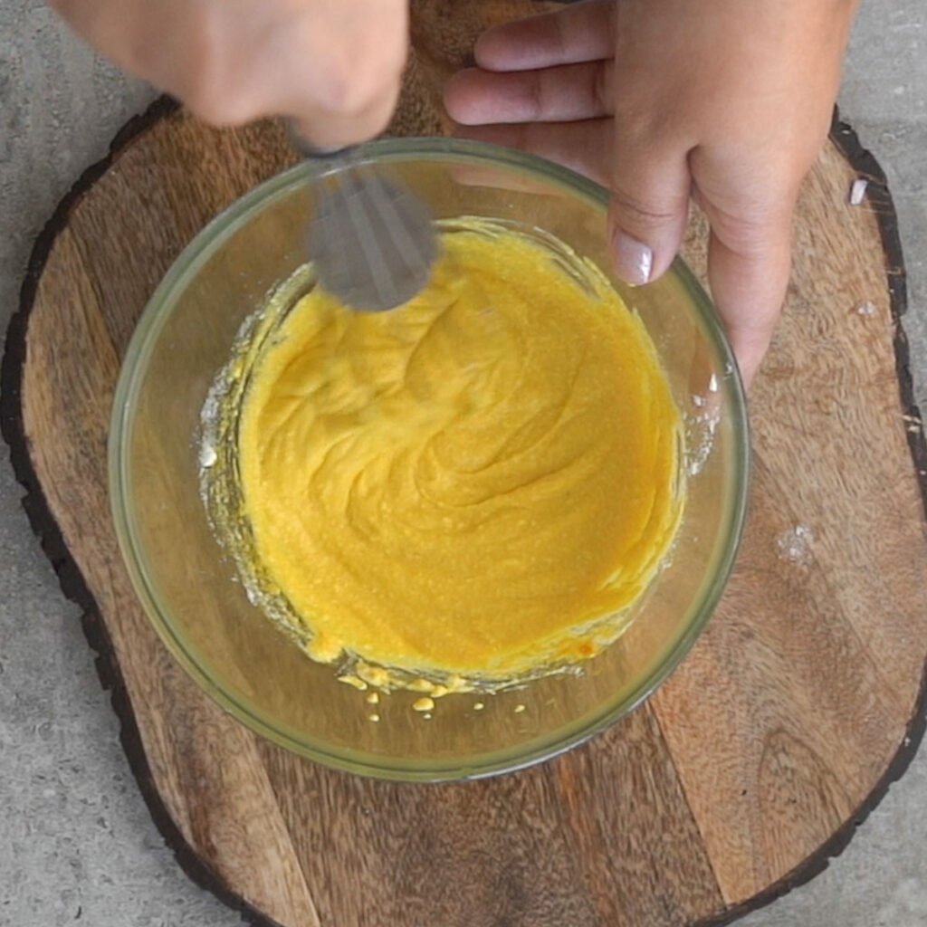 Making the marinade for chicken with yogurt, salt and turmeric