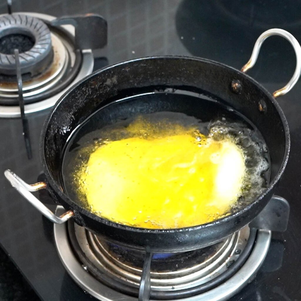 bhatura inside a black wok