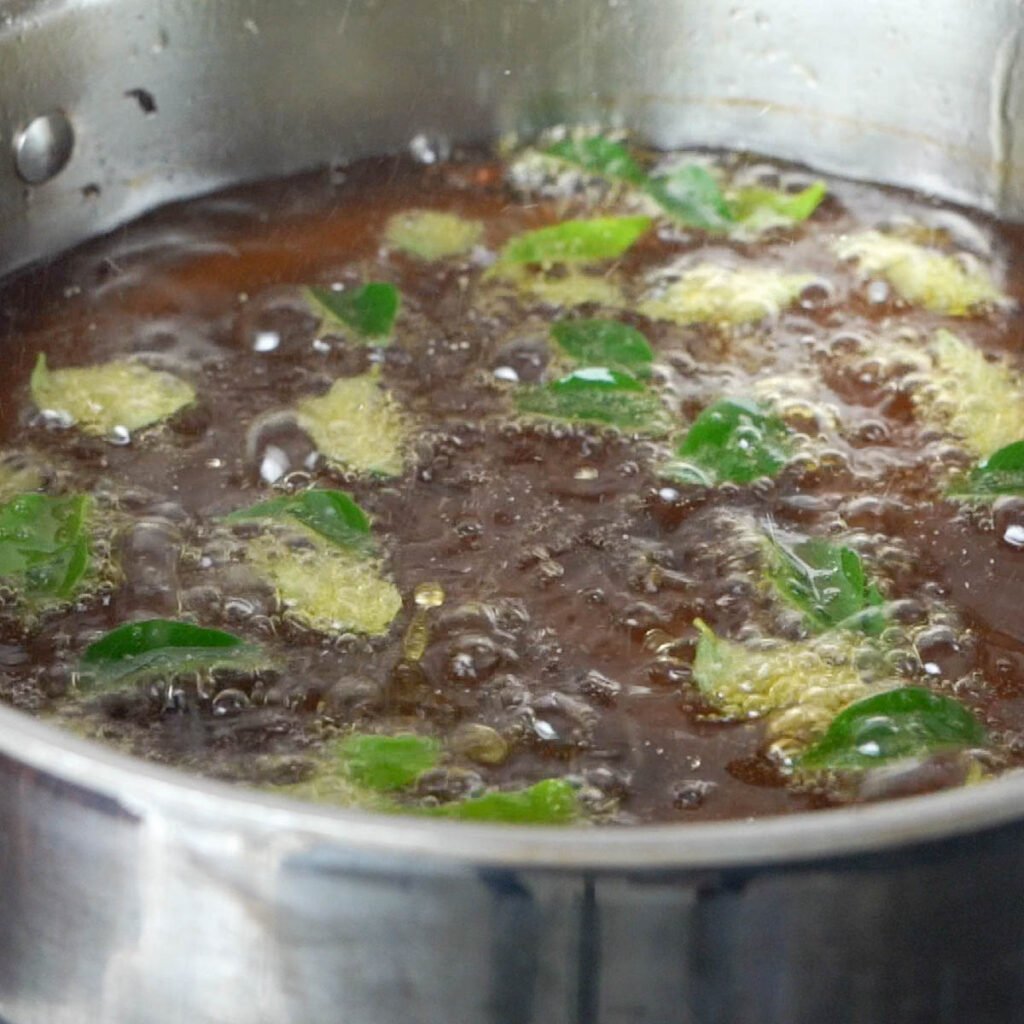 Frying curry leaves  in the oil