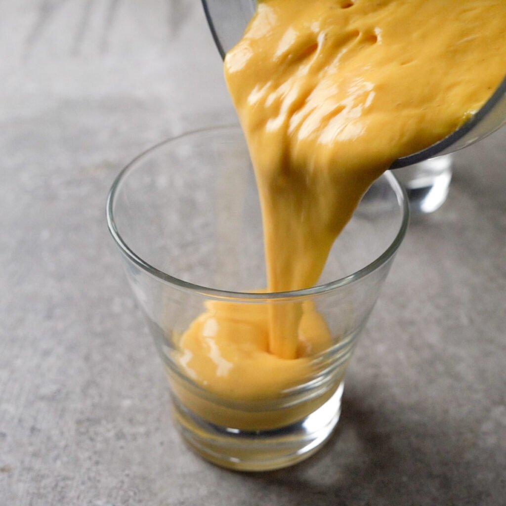 Pouring Mango lassi in a glass