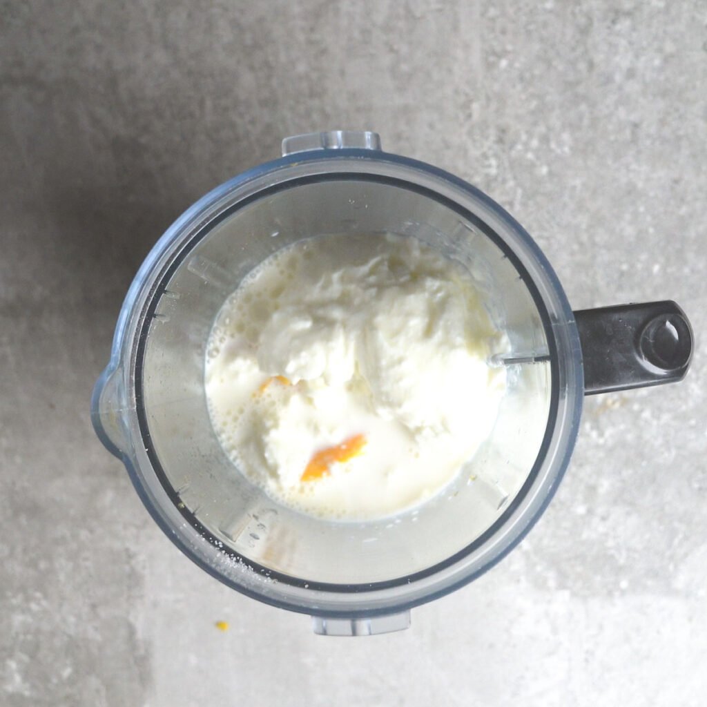 mango cubes, sugar, yogurt and milk in a blender