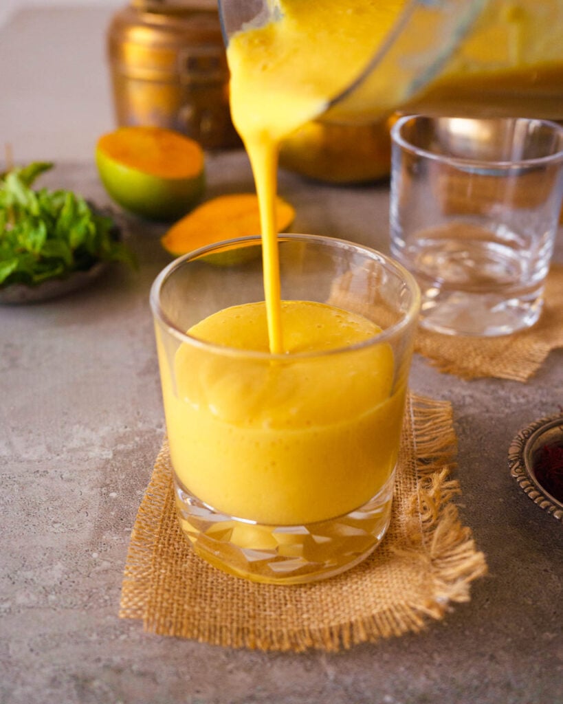 Pouring Mango Lassi in a glass