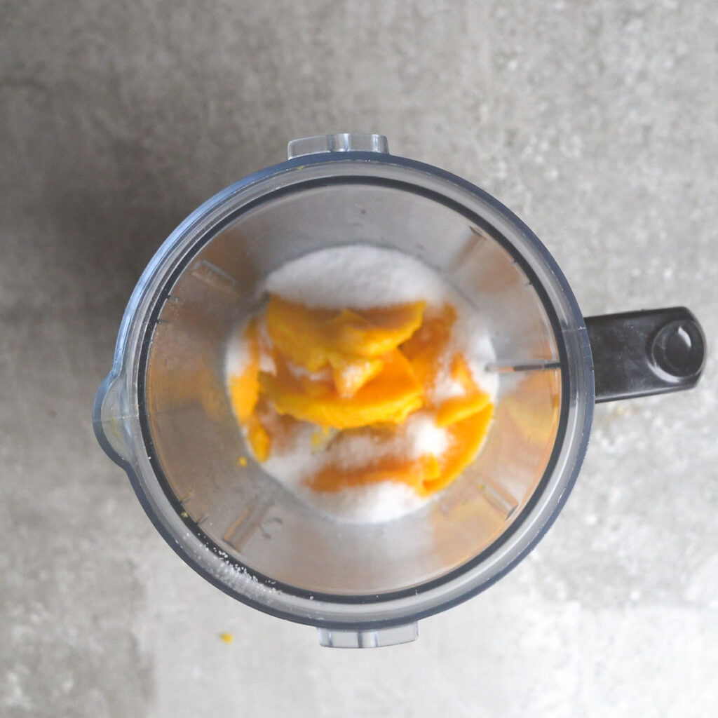 Mango cubes and sugar in a blender