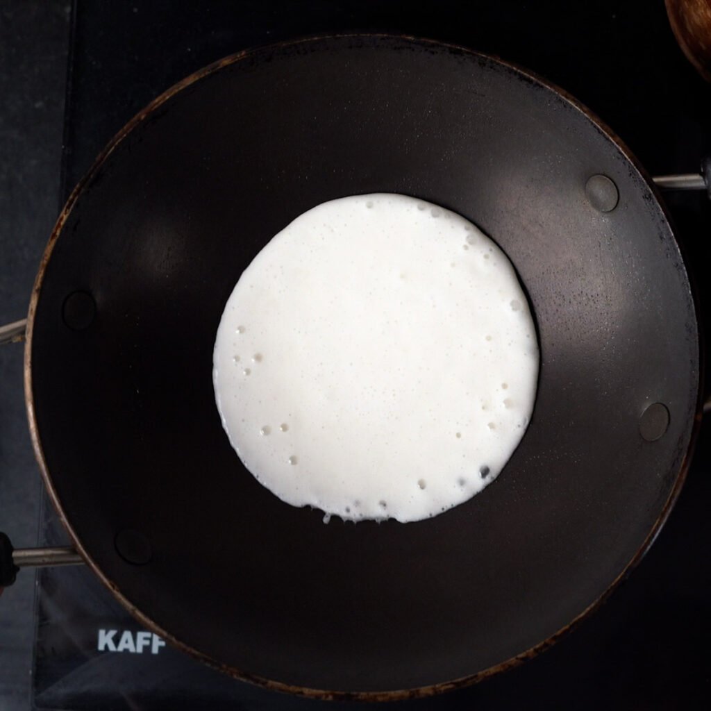 Appam batter in a appam wok or pan