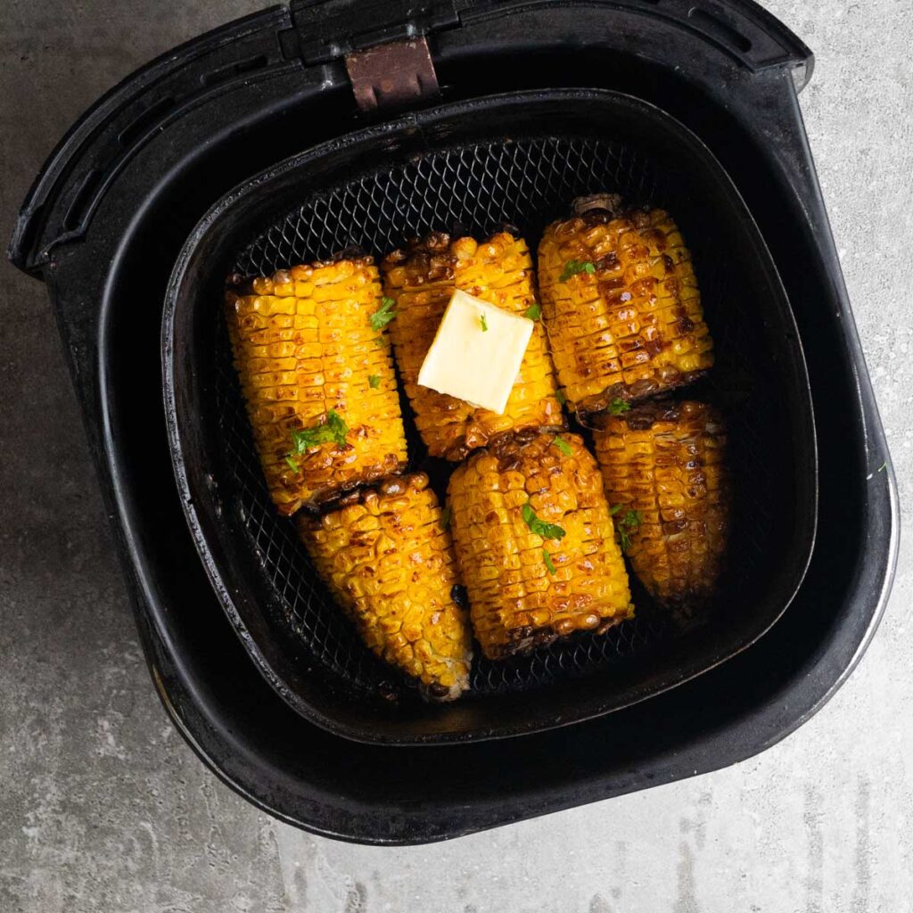 air fryer corn on the cob with a slice of butter