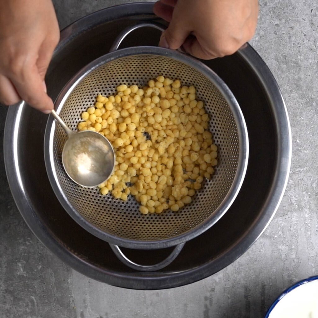 draining the boondi and squeezing excess water out