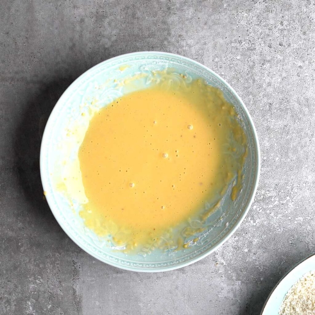 Whisked wet batter to make panko crusted katsu chicken