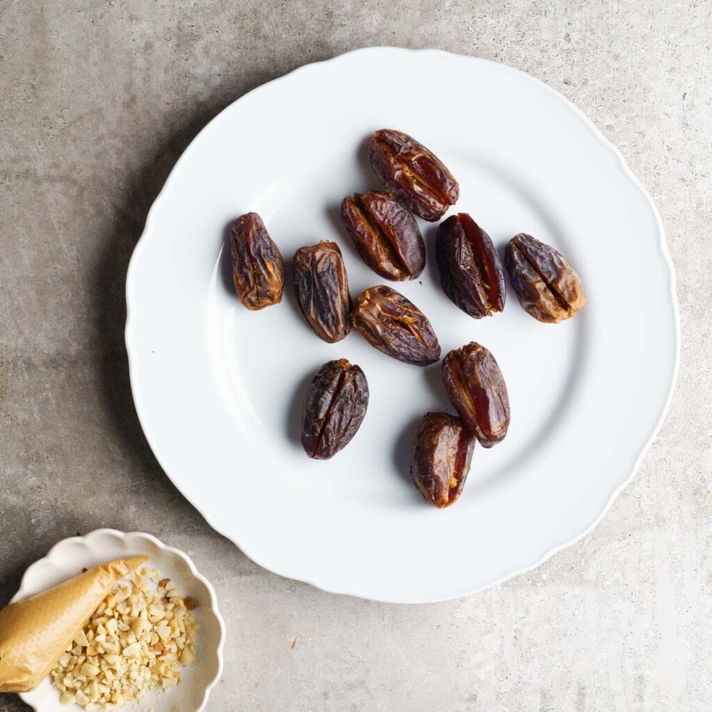 Sliced medjool dates on a white plate