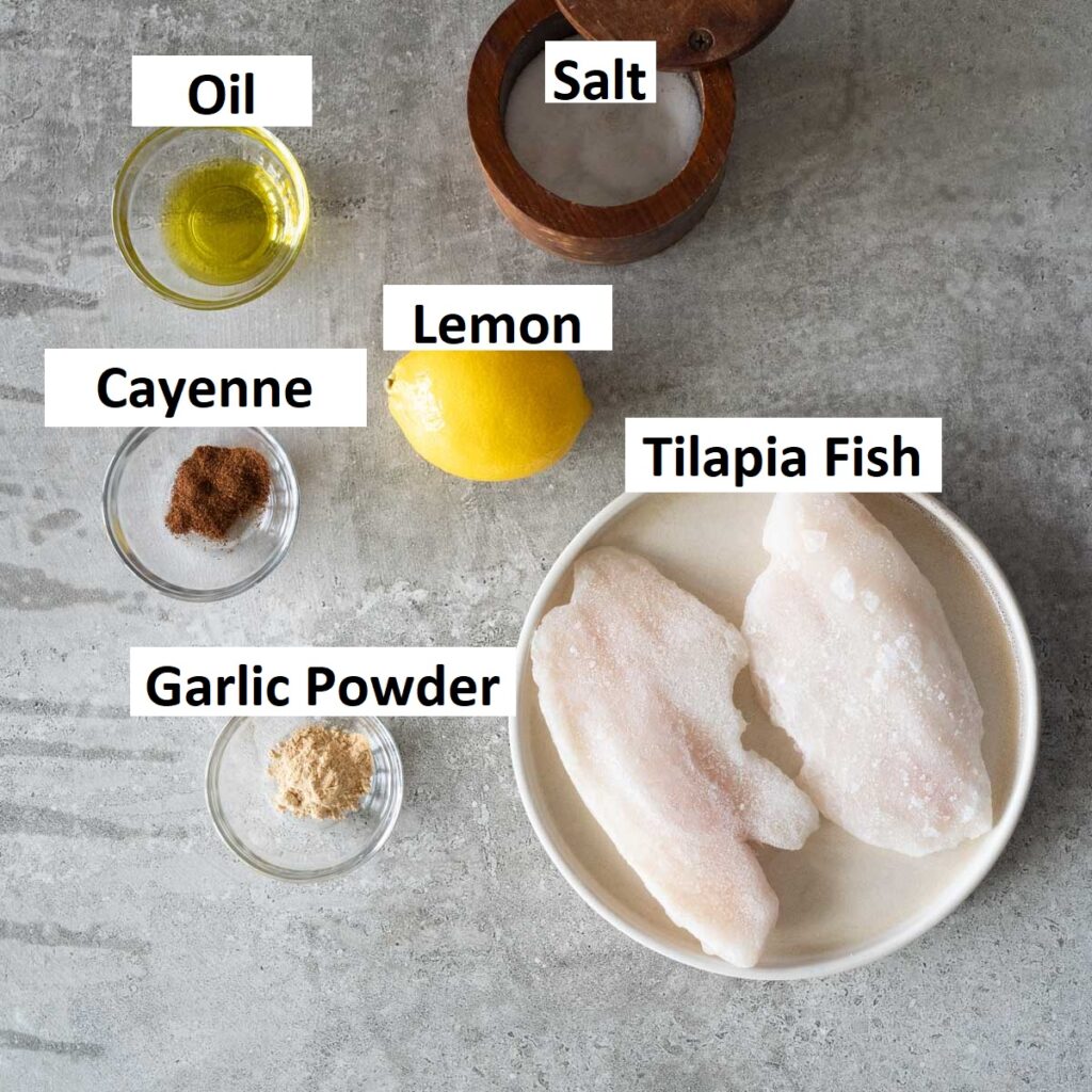 Ingredients needed to make air fryer tilapia fish - lemon, oil, salt, cayenne pepper, garlic powder and lemon 