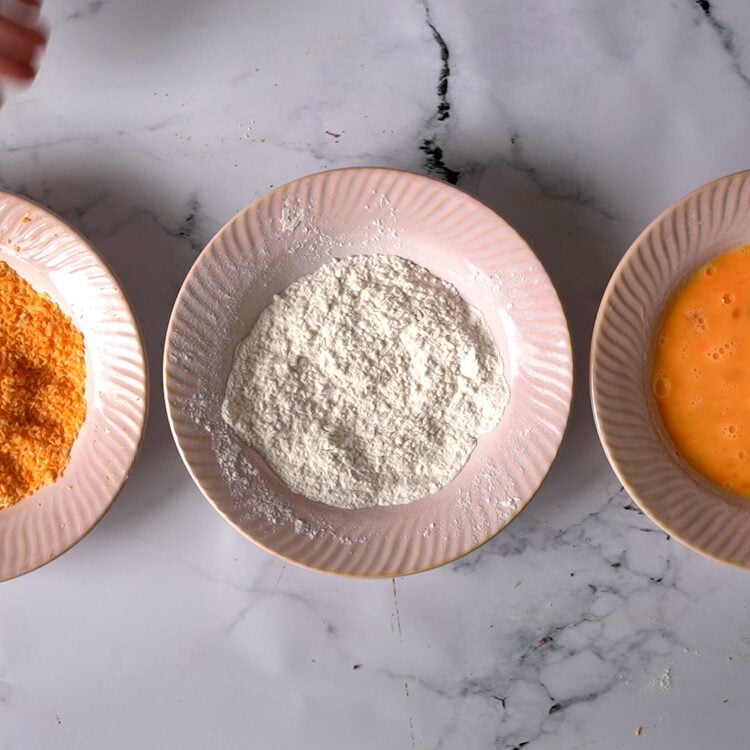 breading station- 3 bowls- one with whisked eggs, one with breadcrumbs and last with flour.