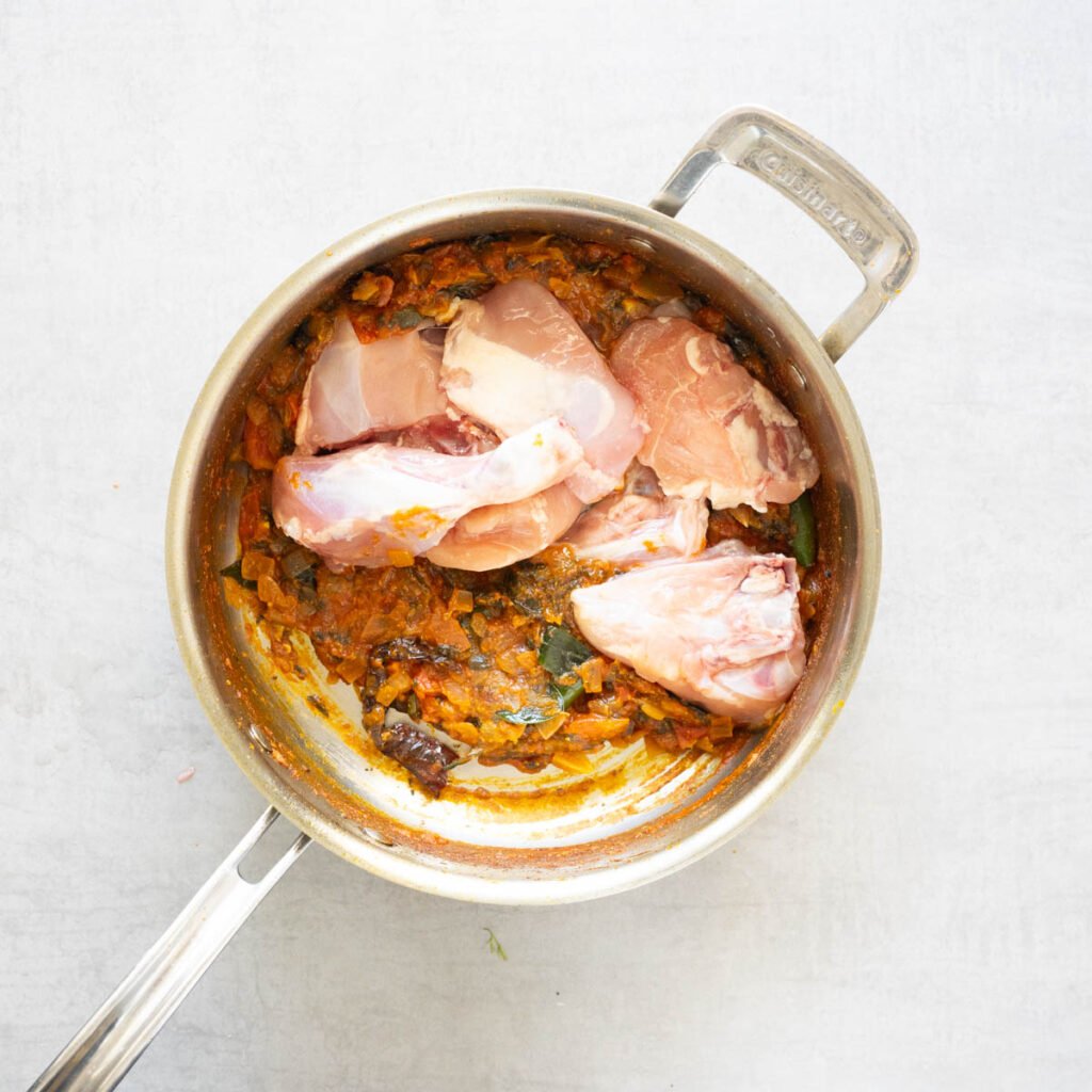 Chicken added to the pan to make gongura chicken curry