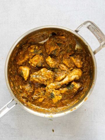 Gongura chicken curry in a steel pan