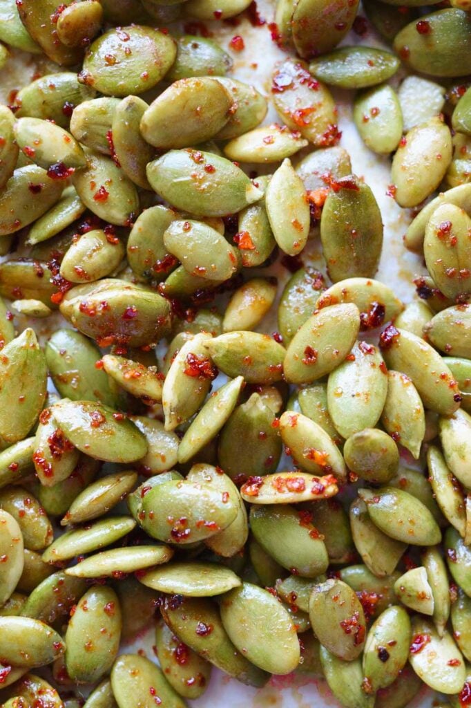 Close up of Roasted chili lime pepitas on a baking tray lined with parchment paper