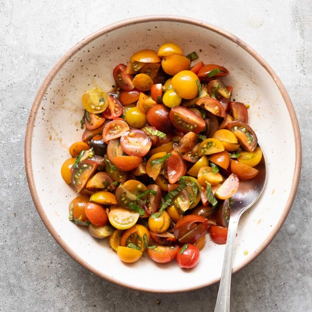 Marinated tomatoes in a white bowl