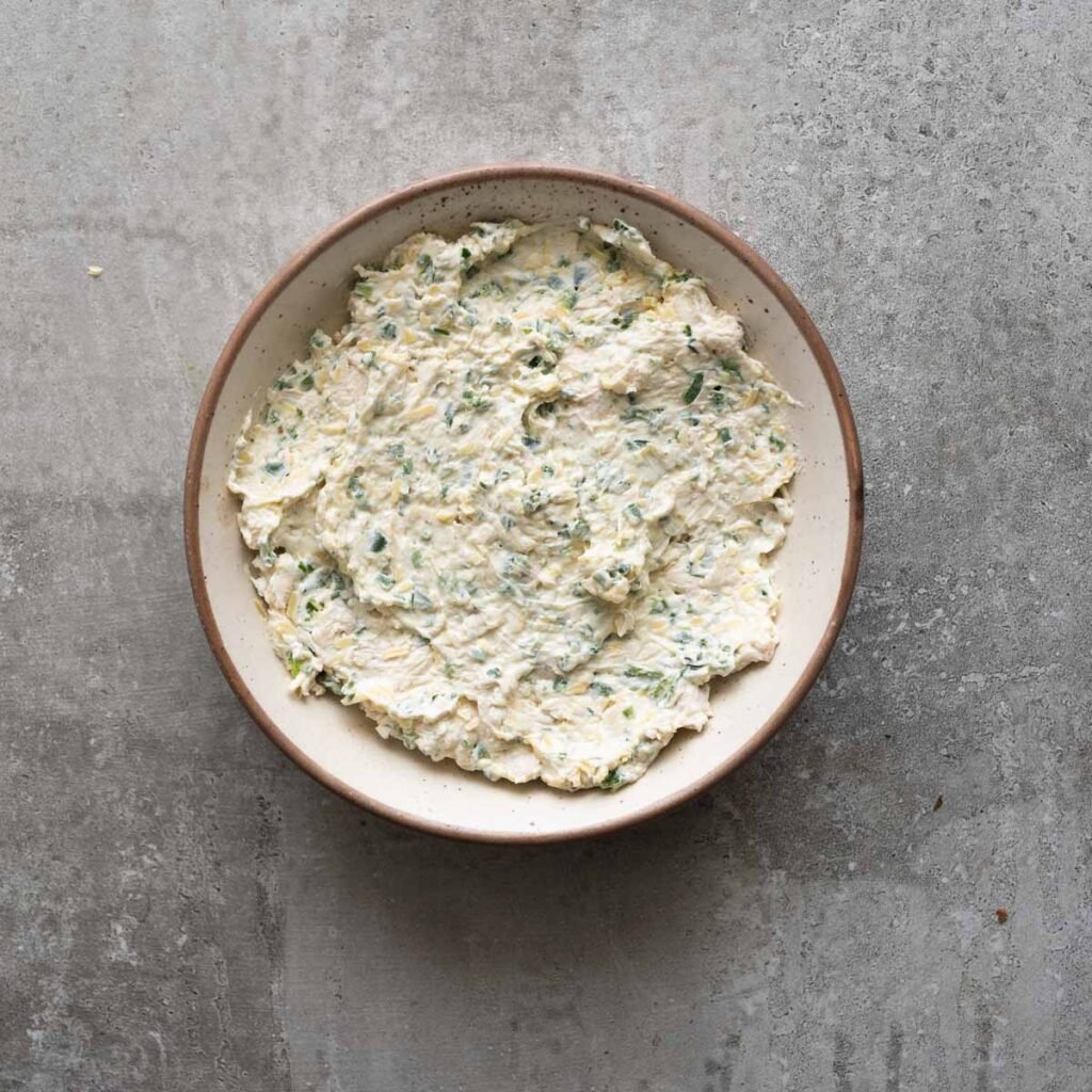 Chicken jalapeno popper mixture inside a baking dish.