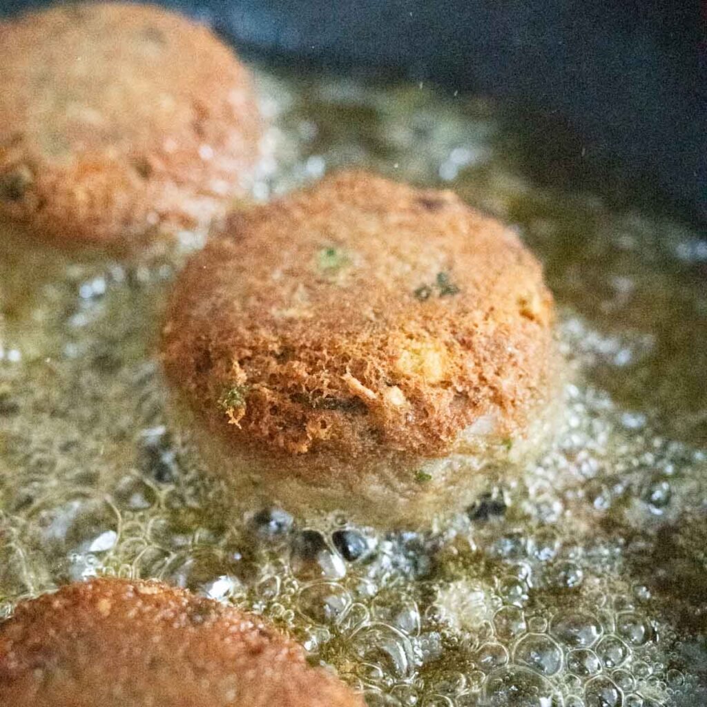 frying shami kebab in ghee in a pan