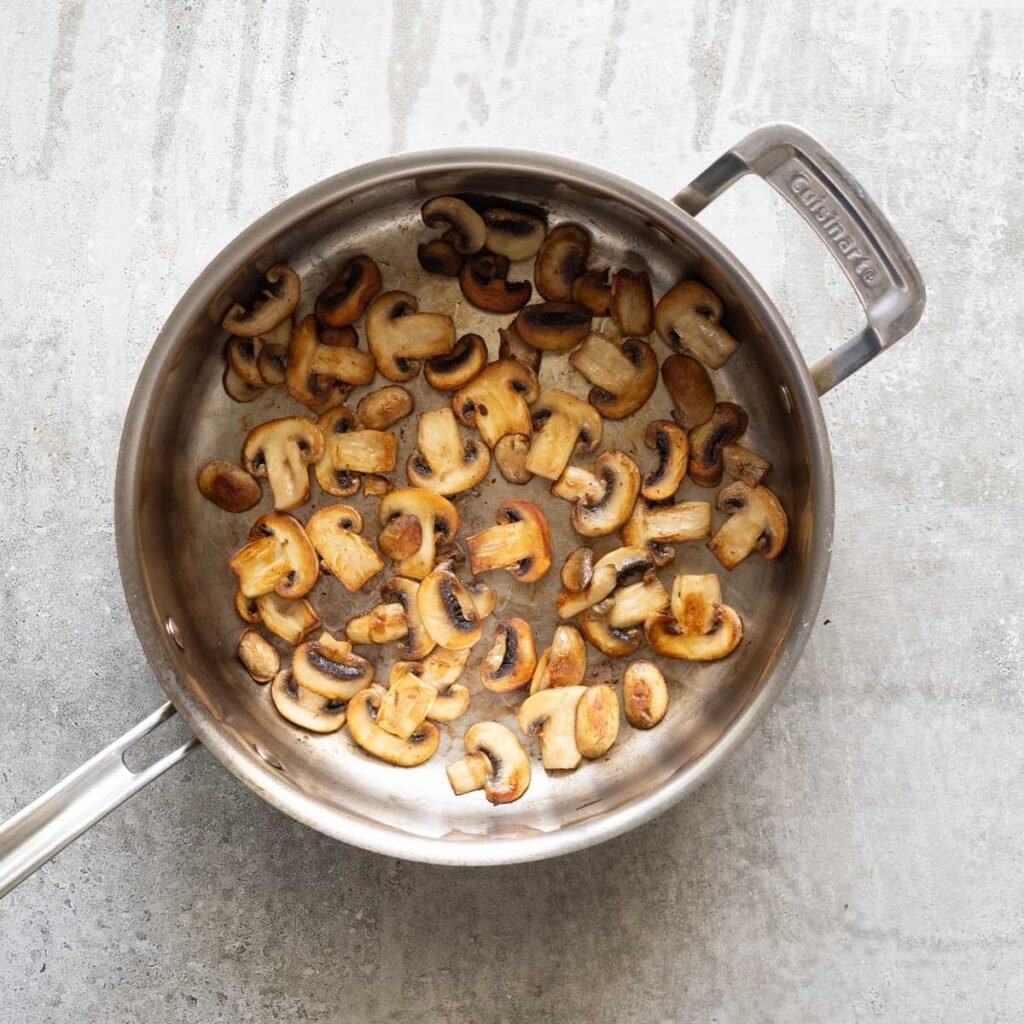 golden mushroom in a stainless steel pan
