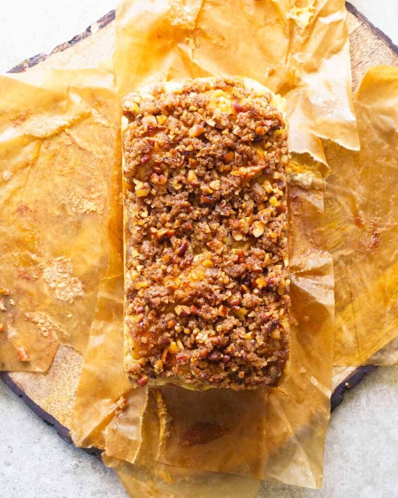 Apple Cinnamon Pecan Babka on a parchment paper with a crispy streusel topping.
