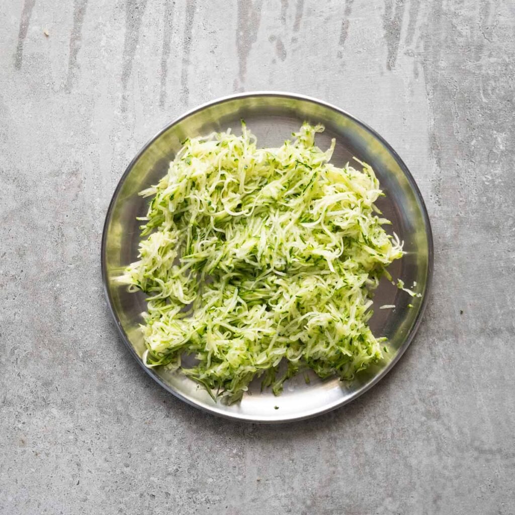 Grated zucchini in a steel plate