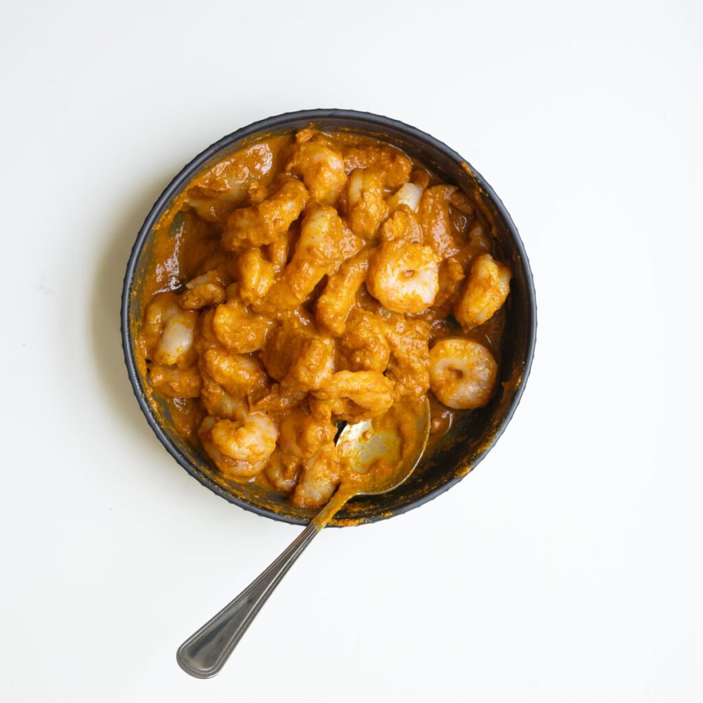 shrimp marinated in a large bowl with a spoon