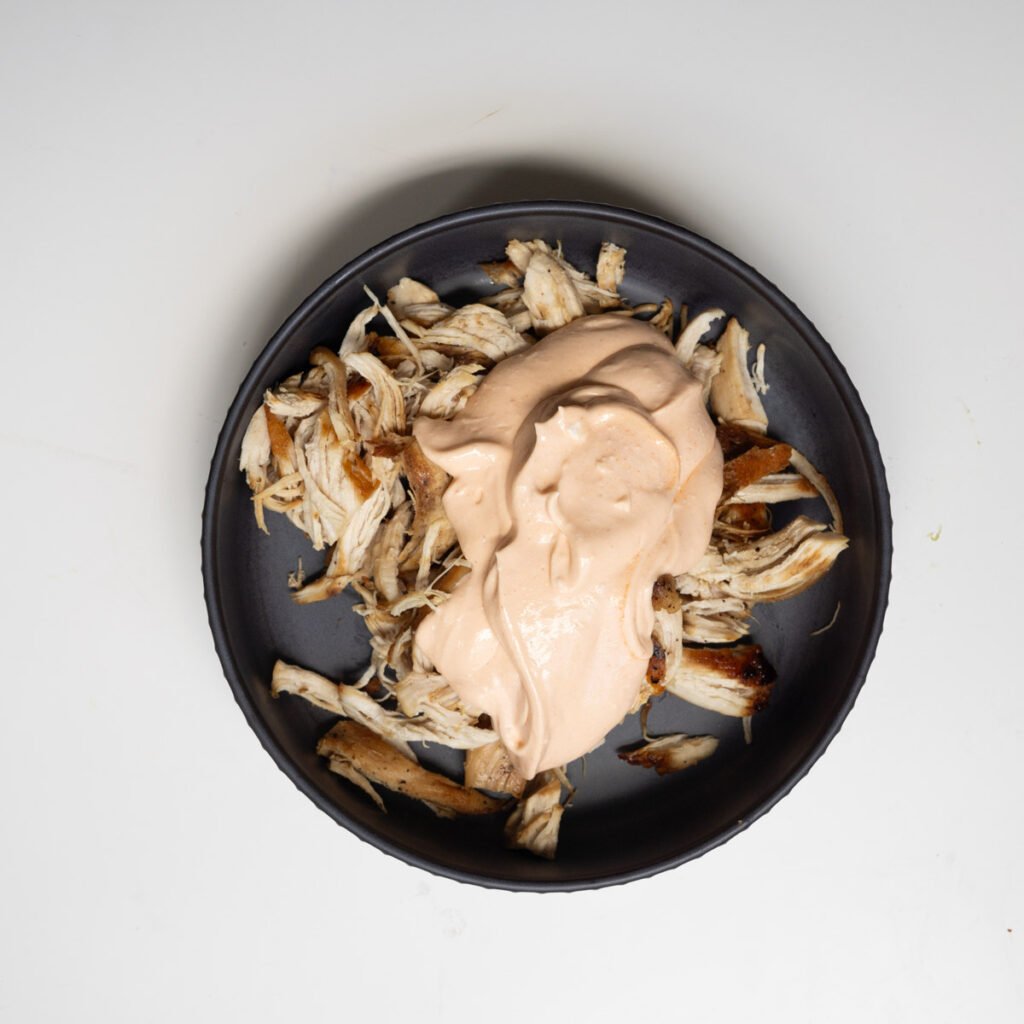 shredded chicken topped with blended cottage cheese and hot sauce