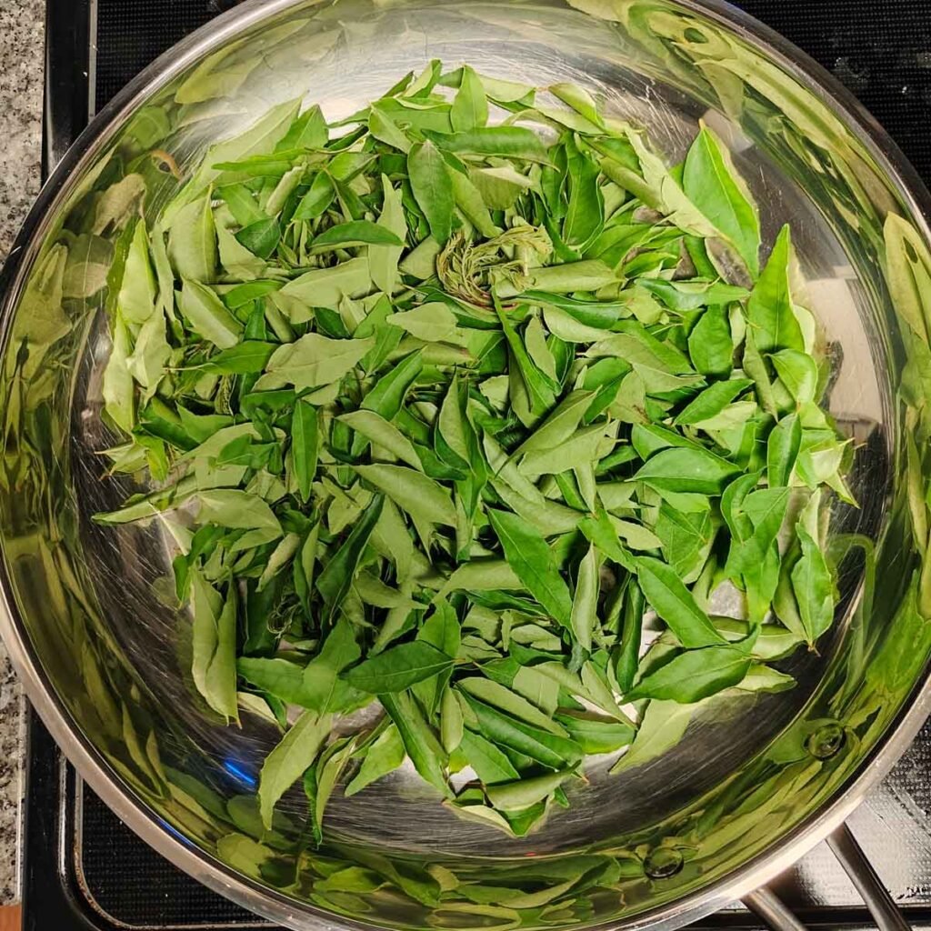 Fresh curry leaves on a pan